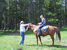 Wendi grabs the reins under the guidance of an experienced Blackfeet horseman